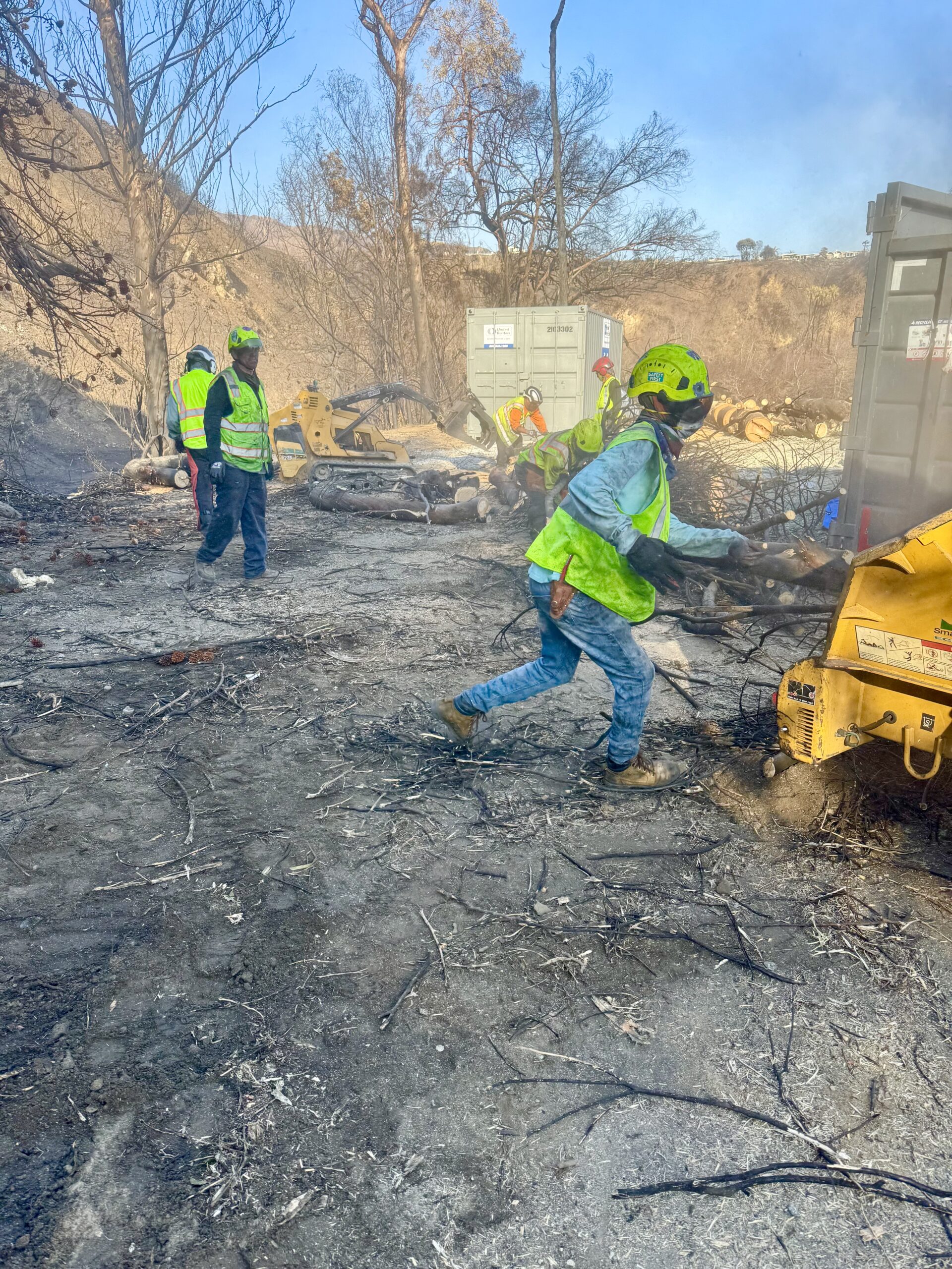 Post-fire tree and brush removal using heavy equipment at a burned property in Los Angeles